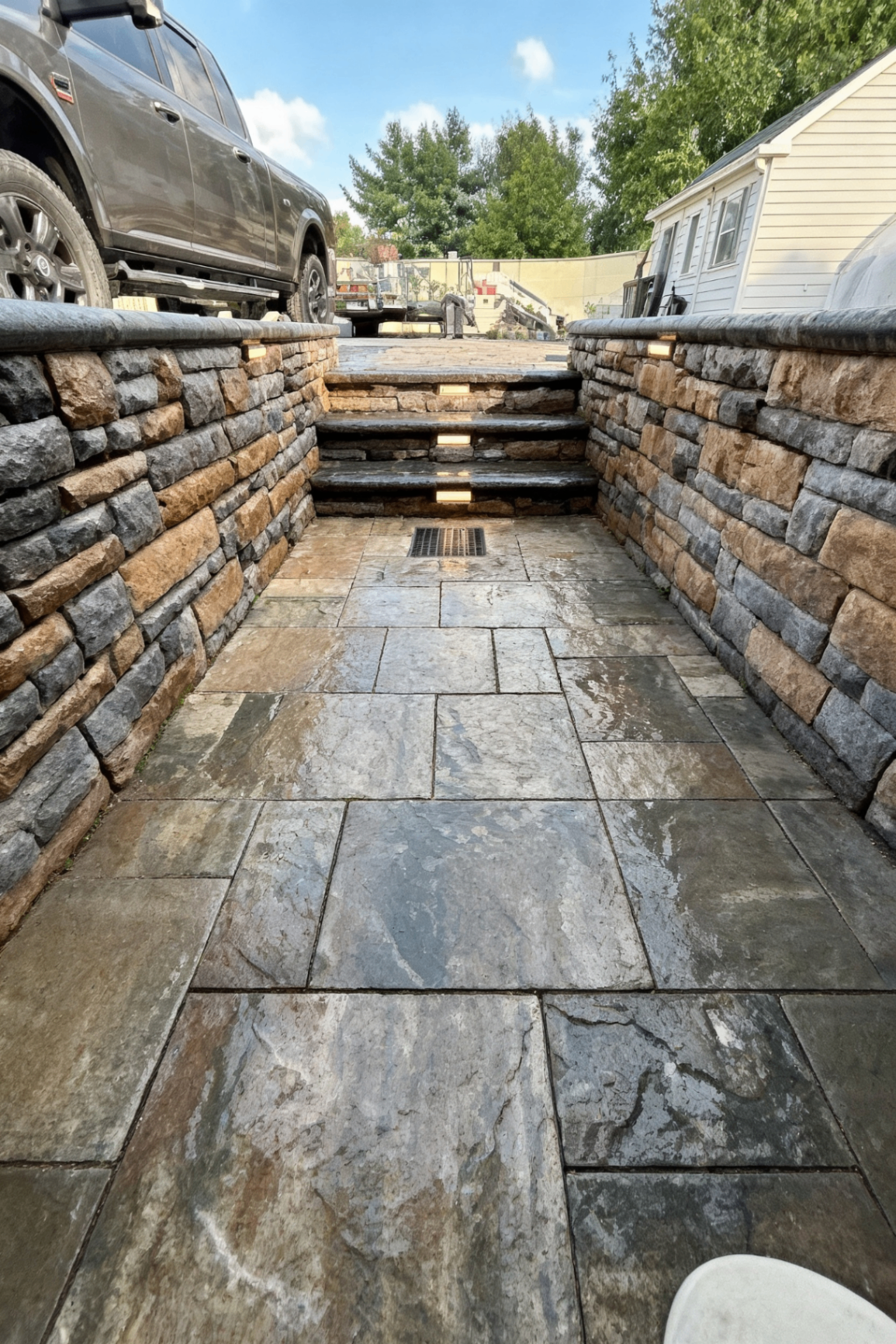 Sunken Stone Patio with Lit Steps